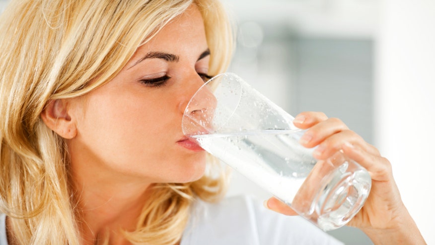 Woman drinking water istock.jpg